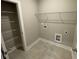 Laundry room with shelving, built-in cabinets, and tile flooring at 3019 Fairway Dr, Villa Rica, GA 30180