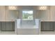 Double vanity bathroom with soaking tub and window at 26 Homesite Cooper E Cv, Fayetteville, GA 30214