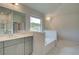 Bathroom with a double vanity and a soaking tub at 26 Homesite Cooper E Cv, Fayetteville, GA 30214