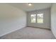 Well-lit bedroom with neutral decor and carpet at 26 Homesite Cooper E Cv, Fayetteville, GA 30214