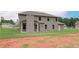 Two-story house with backyard patio and large grassy area at 26 Homesite Cooper E Cv, Fayetteville, GA 30214