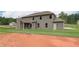 Two-story house with backyard patio and large grassy area at 26 Homesite Cooper E Cv, Fayetteville, GA 30214