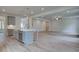 Open kitchen features island, stainless steel appliances, and gray cabinets at 26 Homesite Cooper E Cv, Fayetteville, GA 30214