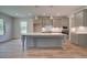 Modern kitchen with gray cabinets, a large island, and stainless steel appliances at 26 Homesite Cooper E Cv, Fayetteville, GA 30214