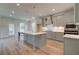 Modern kitchen with gray cabinets, a large island, and stainless steel appliances at 26 Homesite Cooper E Cv, Fayetteville, GA 30214