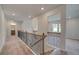 Upstairs hallway with metal railing and carpet at 26 Homesite Cooper E Cv, Fayetteville, GA 30214
