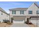 Stylish townhome featuring neutral siding, dark shutters and an attached garage at 2881 Grandin Way, Marietta, GA 30008