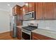 Modern kitchen featuring stainless steel appliances, granite countertops, and rich wood cabinetry at 2881 Grandin Way, Marietta, GA 30008