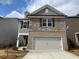 Charming two-story home with a stone and brick facade and attached two-car garage at 4341 Portsbrook Ave, Snellville, GA 30039