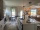 Kitchen and dining room combo with stainless appliances and view into the living room at 4341 Portsbrook Ave, Snellville, GA 30039