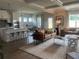 Open-concept living room and kitchen with stainless appliances, hardwood floors, and modern decor at 4341 Portsbrook Ave, Snellville, GA 30039