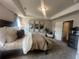 Spacious main bedroom with a tray ceiling, decorative artwork and access to a large closet at 4341 Portsbrook Ave, Snellville, GA 30039