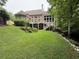 Large brick home with well-manicured backyard and wooden deck at 6163 Talmadge Nw Run, Acworth, GA 30101