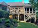 Large brick home with backyard deck and screened in porch and tiered backyard at 6163 Talmadge Nw Run, Acworth, GA 30101