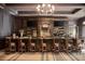 Elegant bar area featuring leather bar stools, a stocked bar, and decorative lighting, perfect for entertaining at 6163 Talmadge Nw Run, Acworth, GA 30101