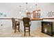 Basement wet bar with wooden countertops, wood shelving and barstools and wine refrigerator at 6163 Talmadge Nw Run, Acworth, GA 30101
