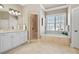 Bright bathroom featuring a double vanity, walk-in shower, and soaking tub at 6163 Talmadge Nw Run, Acworth, GA 30101