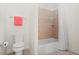 Clean bathroom featuring a toilet, towel bar, and tiled tub-shower combination at 6163 Talmadge Nw Run, Acworth, GA 30101