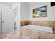 Bathroom with soaking tub with stone tile surround and tile floors at 6163 Talmadge Nw Run, Acworth, GA 30101