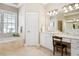 Bright bathroom boasts double vanity, garden tub with window view, and tile flooring at 6163 Talmadge Nw Run, Acworth, GA 30101