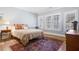 Bedroom with hardwood floors, three windows with shutters and furniture at 6163 Talmadge Nw Run, Acworth, GA 30101