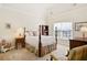 Bedroom with a four-poster bed, window, and neutral carpet at 6163 Talmadge Nw Run, Acworth, GA 30101