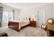 Lovely bedroom showcasing a bed, two side tables, two windows, and sitting chair at 6163 Talmadge Nw Run, Acworth, GA 30101