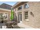 Brick house with patio table and chairs on deck at 6163 Talmadge Nw Run, Acworth, GA 30101