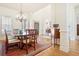 Bright dining room featuring hardwood floors, chandelier, and traditional furniture at 6163 Talmadge Nw Run, Acworth, GA 30101