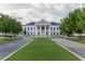 A majestic white building with a columned facade surrounded by a large green lawn at 6163 Talmadge Nw Run, Acworth, GA 30101