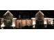 Inviting home exterior with brick facade, shutters, and professional landscape lighting at 6163 Talmadge Nw Run, Acworth, GA 30101