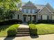 Inviting brick home showcasing a covered porch, well-maintained landscaping, and a welcoming entrance at 6163 Talmadge Nw Run, Acworth, GA 30101