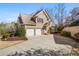 Beautiful brick home with a well-manicured lawn, two-car garage, and a long driveway at 6163 Talmadge Nw Run, Acworth, GA 30101