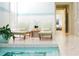 Indoor pool with lounge chairs, white tile, and accent lighting for relaxation at 6163 Talmadge Nw Run, Acworth, GA 30101