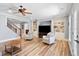 Open-concept living room with hardwood floors, ceiling fan, and built-in shelving at 6163 Talmadge Nw Run, Acworth, GA 30101