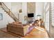 Inviting living room with a stone fireplace, grand piano, and hardwood floors at 6163 Talmadge Nw Run, Acworth, GA 30101