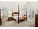 Serene main bedroom with a four-poster bed, a ceiling fan and french doors to the outside at 6163 Talmadge Nw Run, Acworth, GA 30101