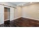 Bedroom with dark hardwood floors and barn doors at 1847 New Ne St, Conyers, GA 30012