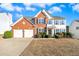 Brick two-story house with attached two-car garage and manicured lawn at 3072 Elmendorf Nw Ln, Kennesaw, GA 30144