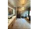 Modern bathroom with double sinks, wood cabinets, a soaking tub, and an elegant chandelier at 3390 Vista Creek Dr, Dacula, GA 30019