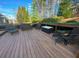 Wooden deck with outdoor seating overlooking a wooded backyard at 3390 Vista Creek Dr, Dacula, GA 30019