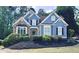 Beautiful blue two-story home with brick accents and a well-manicured front yard at 3390 Vista Creek Dr, Dacula, GA 30019