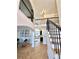 Elegant foyer with gleaming hardwood floors, soaring ceilings, and stylish black iron railing at 3390 Vista Creek Dr, Dacula, GA 30019