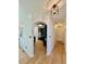 Bright hallway with hardwood floors leading to a modern kitchen with black cabinetry at 3390 Vista Creek Dr, Dacula, GA 30019