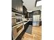 Modern kitchen with black cabinetry, stainless steel appliances, and white countertops at 3390 Vista Creek Dr, Dacula, GA 30019