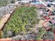 Expansive aerial view of the wooded lot, bordered in red, with surrounding buildings and roads at 1891 Highway 81 E, Mcdonough, GA 30252