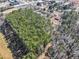Expansive aerial view of the wooded lot and surrounding buildings at 1891 Highway 81 E, Mcdonough, GA 30252