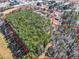 Expansive aerial view of wooded land, bordered in red, with surrounding buildings at 1891 Highway 81 E, Mcdonough, GA 30252