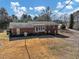 View of the back of a beautiful brick home with a backyard at 1891 Highway 81 E, Mcdonough, GA 30252