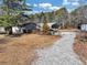 Backyard with multiple garages with gravel driveway at 1891 Highway 81 E, Mcdonough, GA 30252